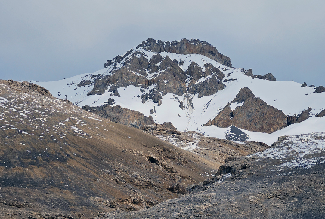 Monto III (ca 6,250m GPS) from the west. The ascent followed the right skyline to the headwall then made a long traverse right to gain the south ridge, which was followed back left to the summit. A large cairn on top indicated a previous ascent by an unknown route. 