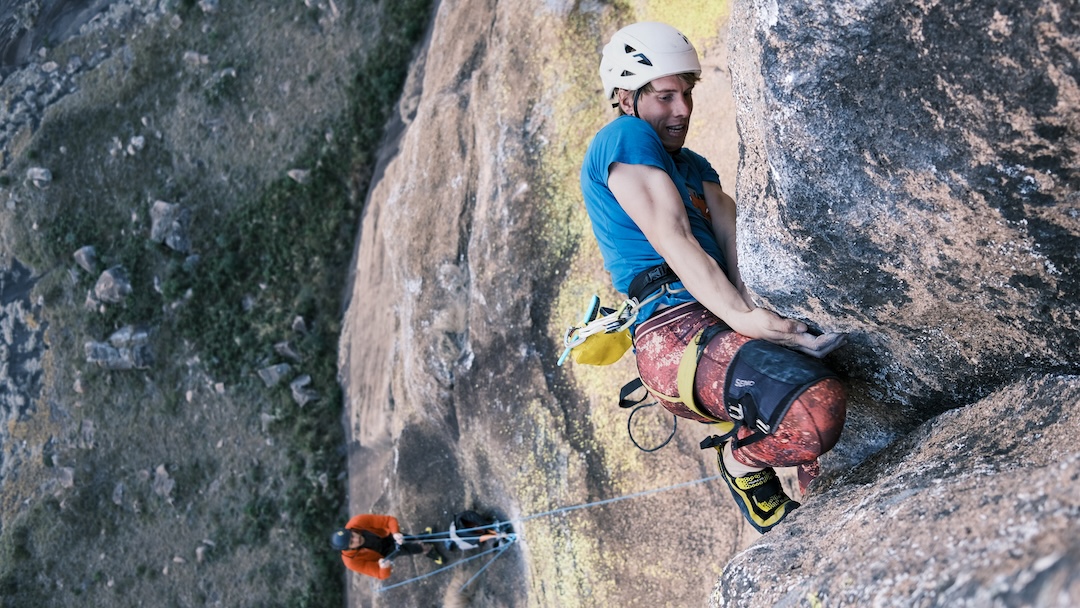 Luan Gäumann kneebars through the sixth pitch (7c+), the crux, on the 300-meter route Famadihana, located on the east face of Mitsinjoarivo. 