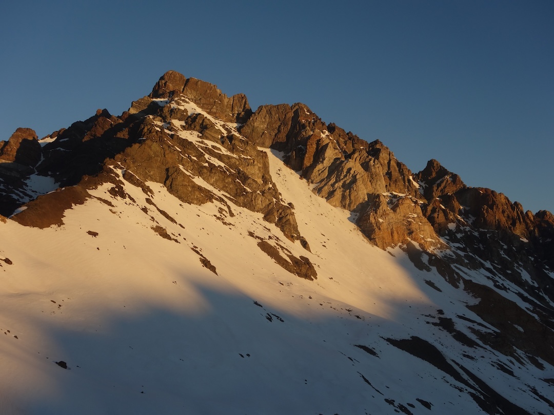 The west face of Cerro Socavones. The first ascent followed the prominent snow gully, traversed left to reach the rocky northwest ridge, then circled around the north and east faces to the top.