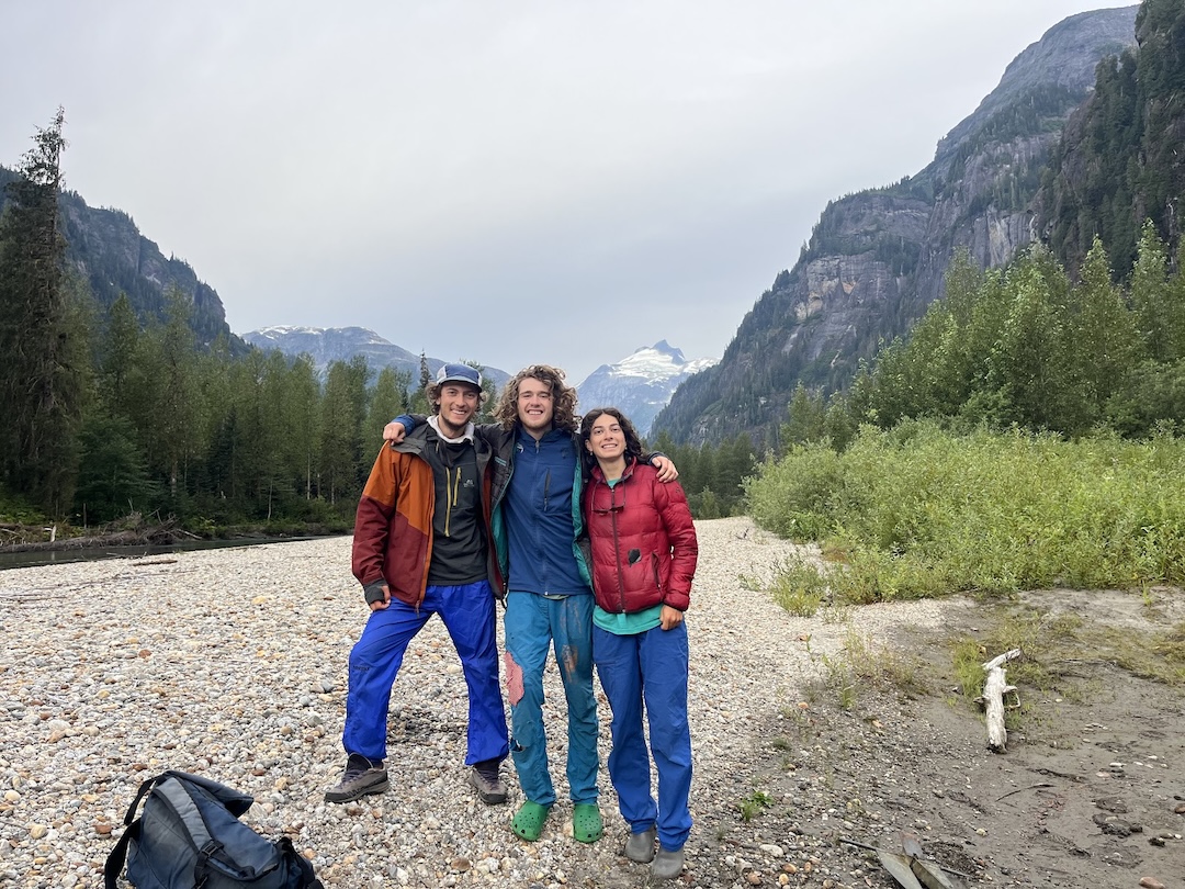 Savian Czerny, Wiley Holbrooke, and Anna Feldman (left to right), just before getting on the jet boat to leave. Gilt Peak is the prominent glaciated peak in the background. 