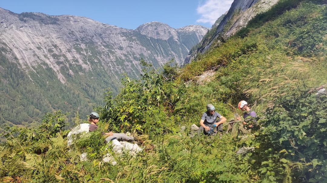 Cameron Jackson, Taylor Ramljak, and Carson Wright filtering water from a small pool at the base of the route. 
