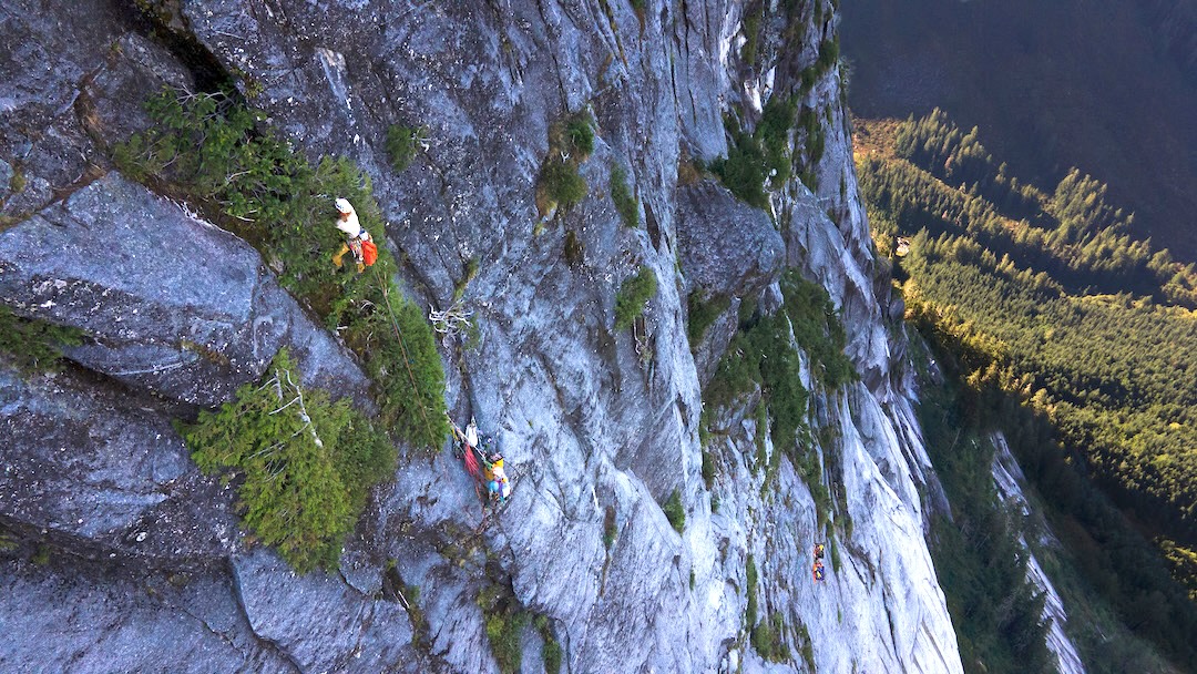 Mike Friesen leading in the trees on pitch 17, with Cameron Jackson belaying below. The team’s high camp can be seen further below and slightly right. 