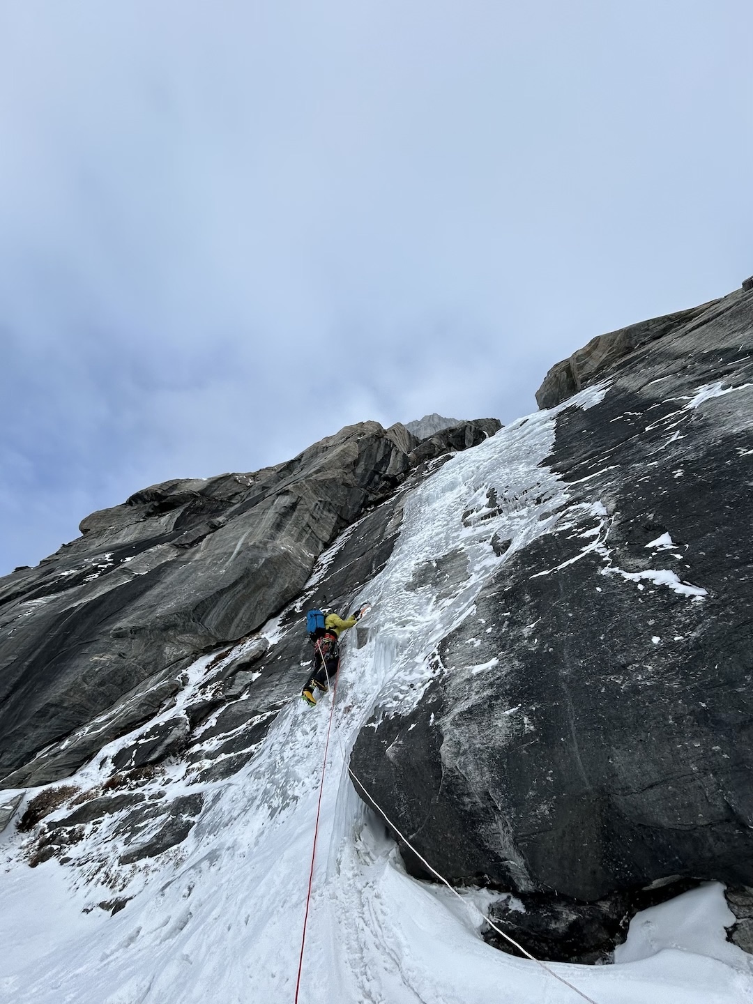Erik Boomer leading pitch one off the sea ice to start up the west face of Sikunga Mountain. 