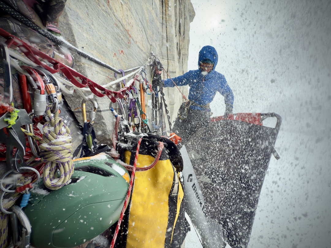 Kylus Hart packing up camp in less than ideal conditions. Hart and Erik Boomer spent 23 nights in the portaledge during the first ascent of Sikunga Express.