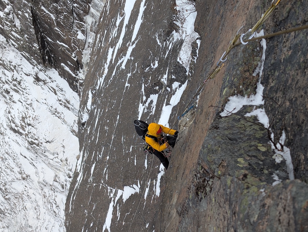 Cleaning a steep rock pitch on Les Chercheurs d’Or. 