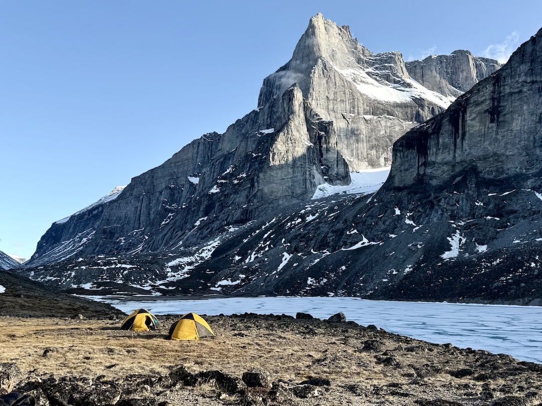 Base camp below Eglinton Tower, with the unclimbed northeast pillar and east face of Damocles (1,619m) in back. Damocles was first climbed, from the south, in 1979. 