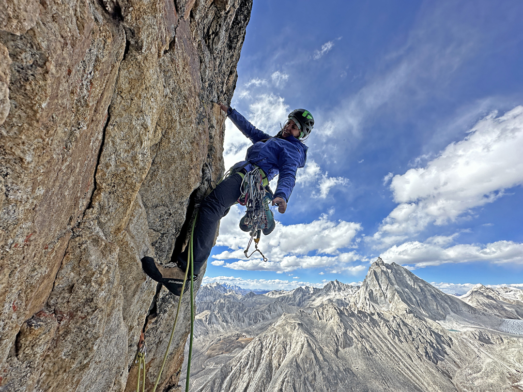 Fanny Schmutz on a steep pitch in the middle section of Grad Kristalov, Peak 5,600m. The dry rock pyramid behind is Hutsa (5,863), first climbed in 2016.