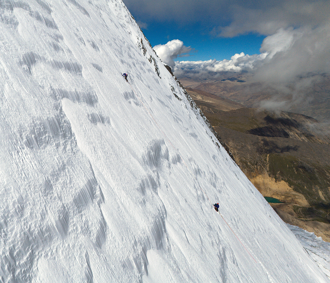 A drone photo of the three climbers on the north face of Guoraka Ri. 