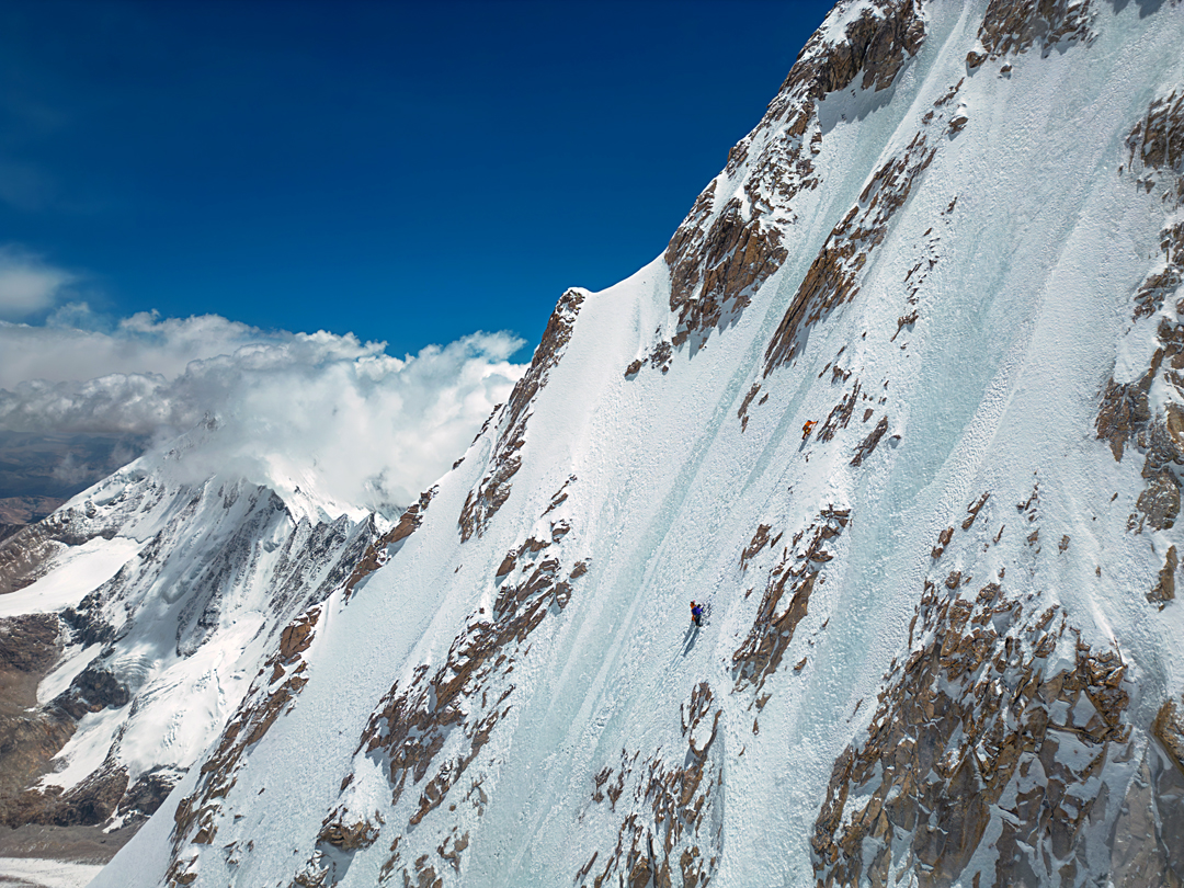 In the middle section of the northwest face of Kangmi Kangri. The peak in the background (summit in cloud) is Guoraka Ri, climbed later in the year.
