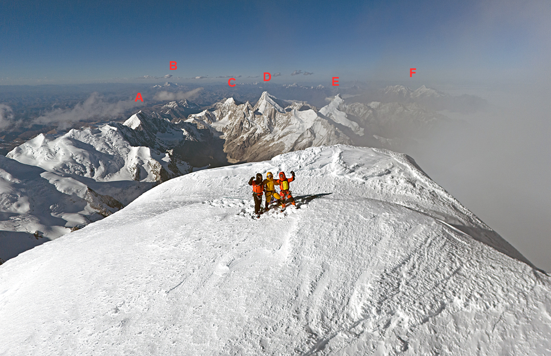 Chen Chujun, Tong Haijun, and Wang Yongpeng on the summit of Minya Konka, having made the second ascent—this time to the highest point of the mountain—of Tong's 2018 route up the north spur and northeast ridge. Behind and to the north lie (A) Reddomain (6,112m), (B) Haizi Shan (5,820m), (C) Grosvenor (6,376m), (D) Jiazi (6,540m), (E) Edgar (6,618m), (F) the Tatsienlu Massif (highest peak, Lamo-che, 6,070m). 