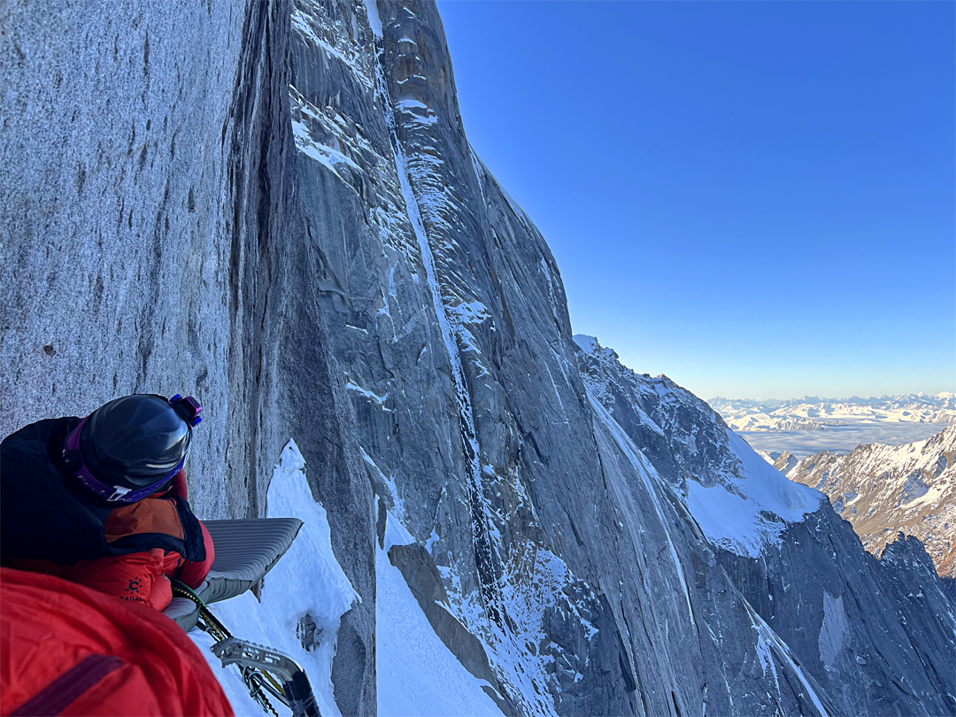 The second bivouac (5,650m) during the ascent of the west flank approach to the north ridge of Siguniang. Splitting the northwest buttress behind is the narrow ice couloir—the Inside Line—climbed in 2002 by Mick Fowler and Paul Ramsden. 