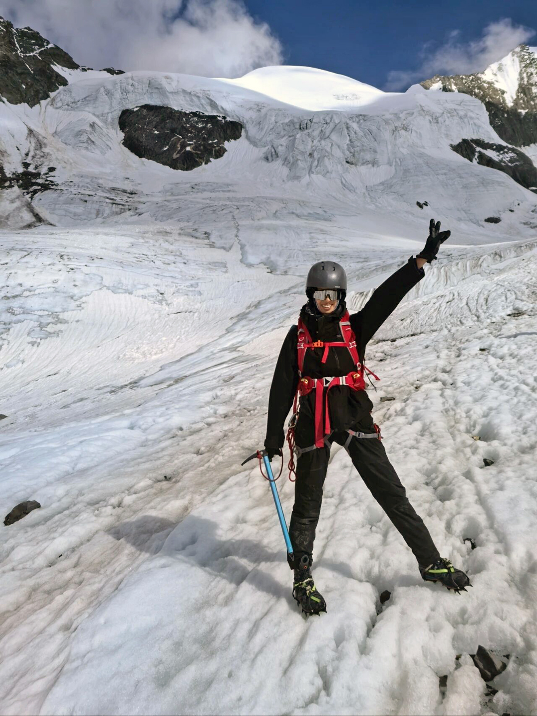 On the upper glacier below the west face of Xue Yue Feng. The route through the serac barrier climbed directly above the climber's outstretched hand. 