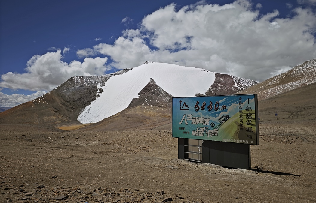 The north face of Rimuza (6,180m) seen from the 5,830m Laqiong La, the latter often cited as the highest motorable pass in China. The August 2025 route climbed to the apex of the rocky triangle in the center of the face, then directly up snow to the summit. Descent was along the right skyline ridge.  