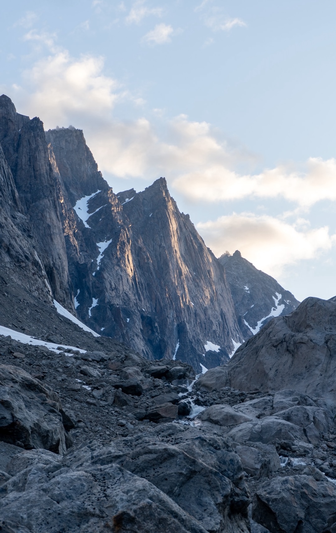 Morning sun lights up the faces, as seen from base camp. 