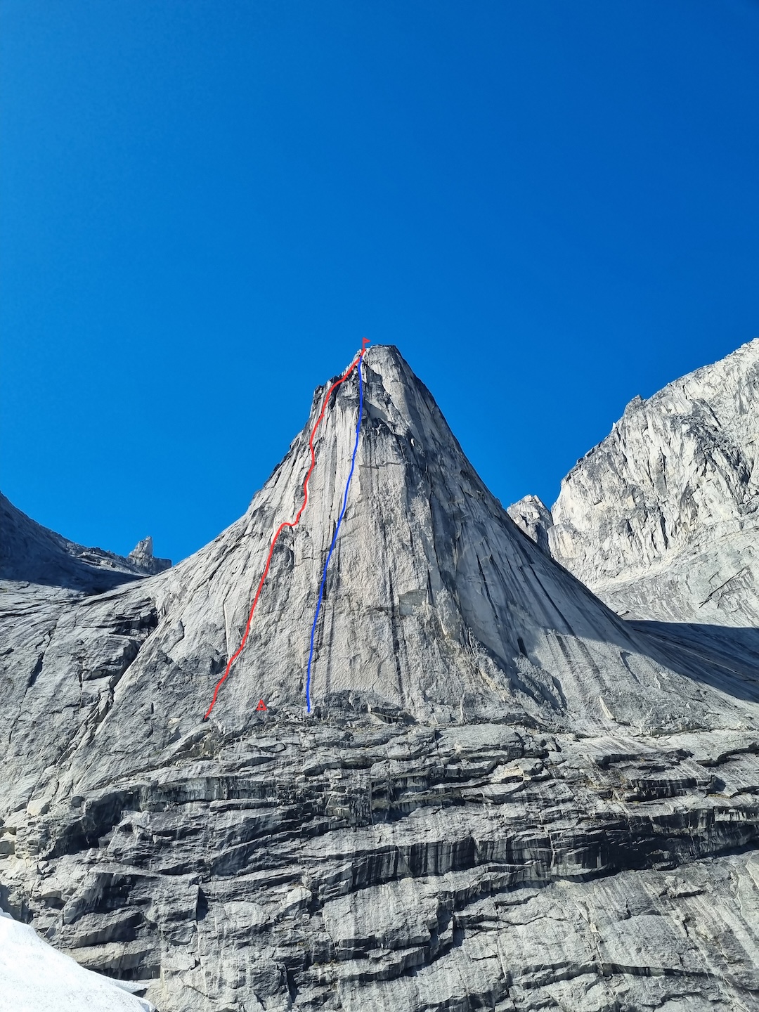 The Honey Buttress with (left, red line) the 10-pitch route repeated by the New Zealand team (probably part or all of the 1998 British Route) and (right, blue line) the general line of Manuka (5.12).  
