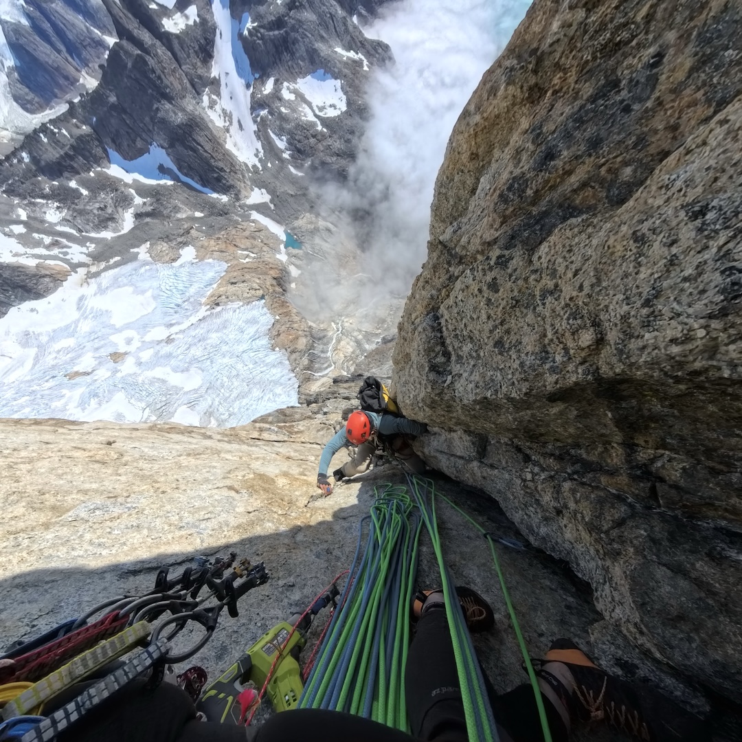 Marco Dattolo cleaning the gear on the second pitch (6b) of the upper headwall on the southwest side of Titan II. 
