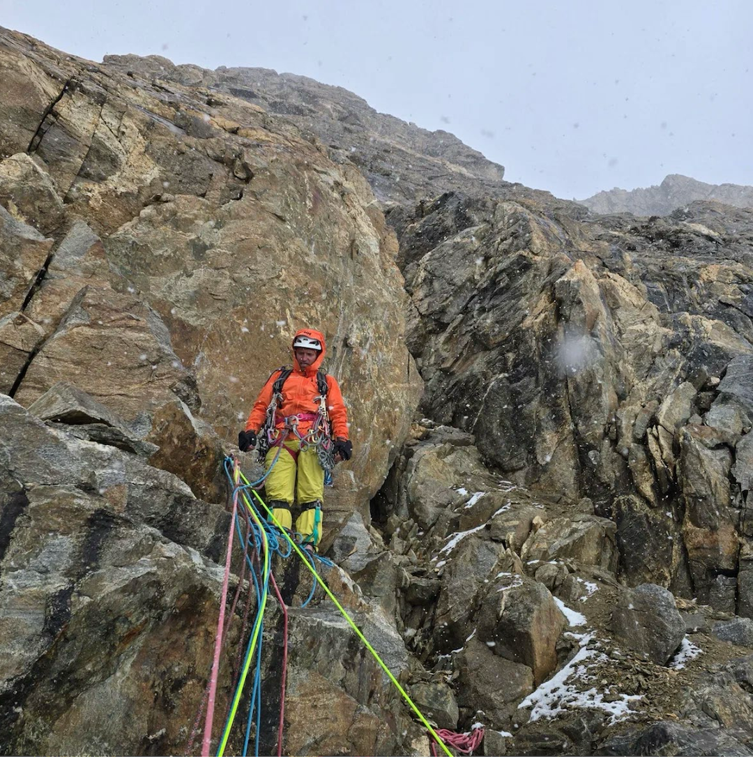 Around noon, snow began to fall and the wind strengthened, leaving everything wet and cold. Rather than stop and wait, the team chose to keep pushing upward. As this was a first ascent, they had no way of knowing what difficulties lay ahead, so they accepted a slower pace rather than risk losing valuable time. Alexander Sokolov is pictured.