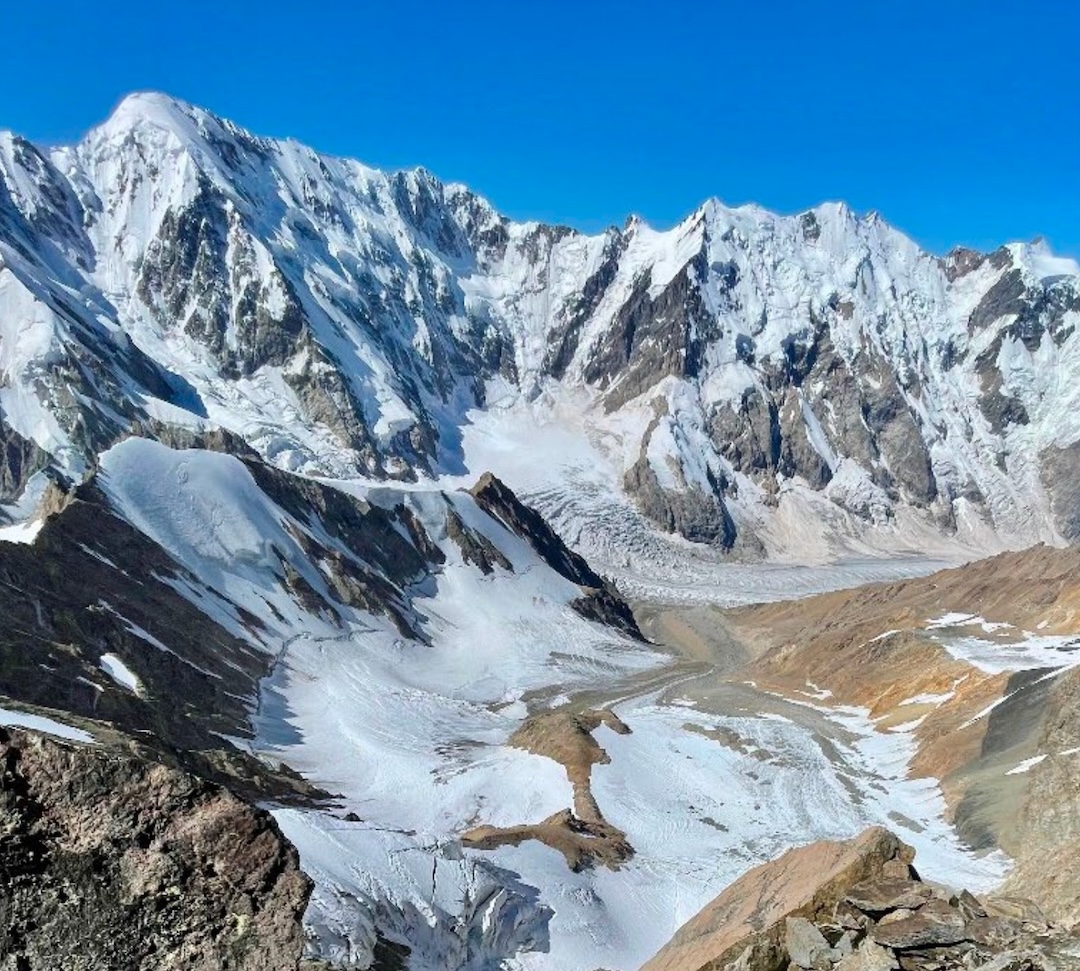 View of the Bezengi Wall and the Sella Glacier below Mizhirgi West, photographed from the team's bivouac at approximately 4,600 m.