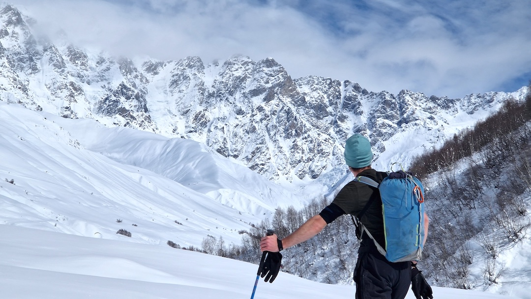 Márton Nagy checking snow conditions and getting a first look at the wall on Shkhara in February 2025.