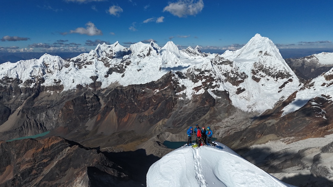 Drone view of the team on the summit of Santa Cruz Chico, with the north side of the Cordillera Blanca in back. Quitaraju is prominent on the right, Alpamayo in the center, the fang of Taulliraju to Alpamayo’s right, and the Pucajirca group to its left.