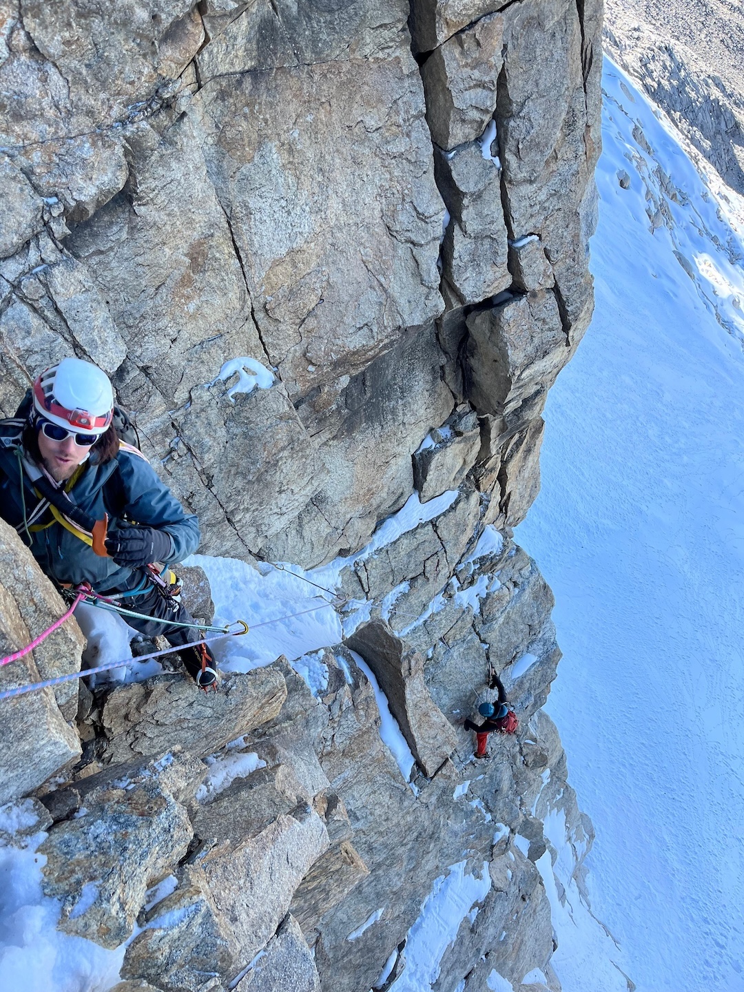 Maximiliano Arias looking to solve a boulder problem on pitch one (crux). Eduardo Tapia is below in a sustained rock section. 