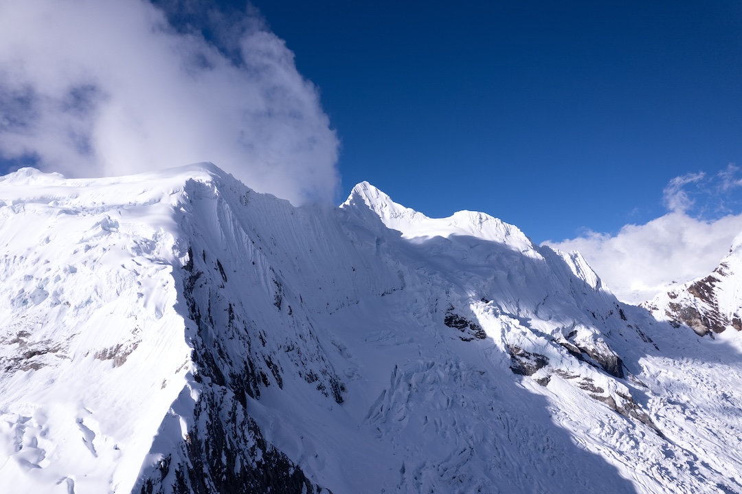 Drone photo of Palcaraju Oeste and Nevado Palcaraju. The approach to Palcaraju passed under the shaded face in the foreground.