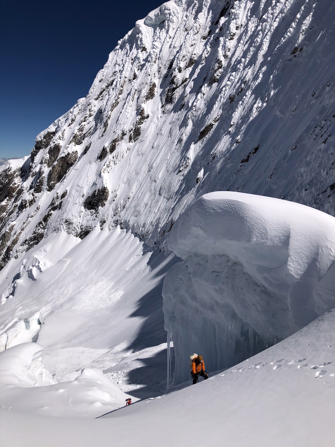 Dane Christensen and Matt Stacy walking the final meters to Camp 1 on Palcaraju, relieved to get out from under the headwall separating Palcaraju Oeste and the main summit. 
