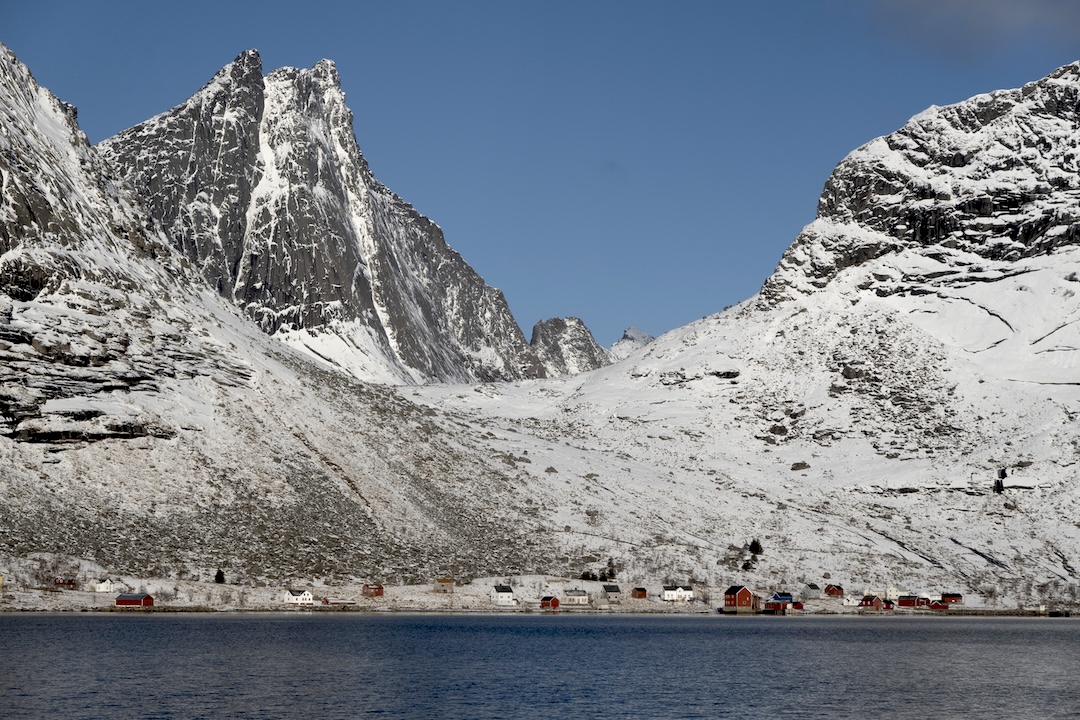 The east face of Breiflogtinden as seen from the ferry, with the hamlet of Kjerkfjorden below. No Helicopters climbed the left of the two obvious gullies to the ridge, then traversed south (rightward) to the summit. 