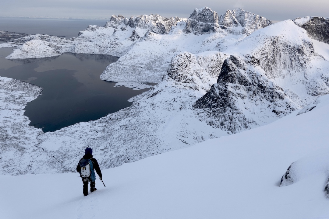 Stian Bruvoll descending toward Solbjørnvatnet after making the first ascent of Follow the Rabbit on Kråkhammartinden. The prominent wall at center-right is the north face of Klokktinden, where Bruvoll and Wright climbed two new routes in 2023. 