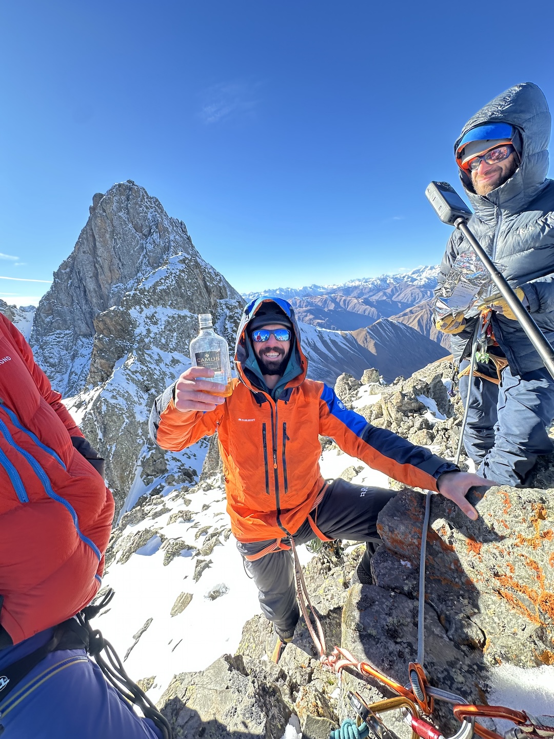 Temo Qurdiani (center) and Giorgi Tepnadze toasting the late Archil Badriashvili on top of of Archil Peak. The peak in back is Asatiani. 