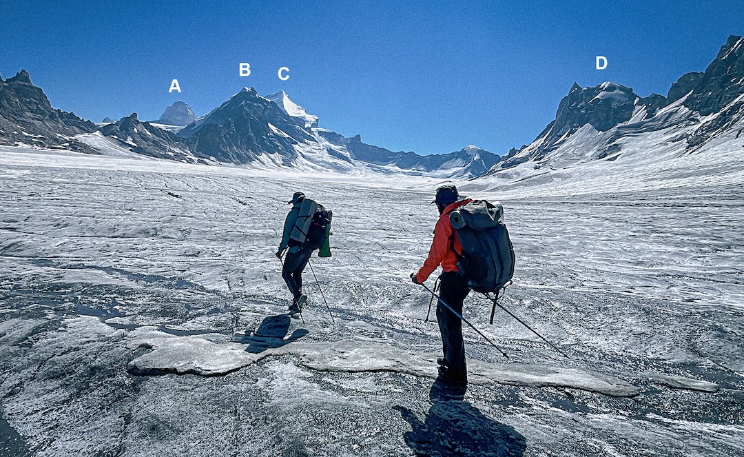 Crossing the vast Barmal Glacier toward the Sentik La, looking northeast at (A) Kun (7,077m), (B) D 41 (6,077m), (C) Nun (7,135m), and (D) Nieve Penitente (5,552m). 