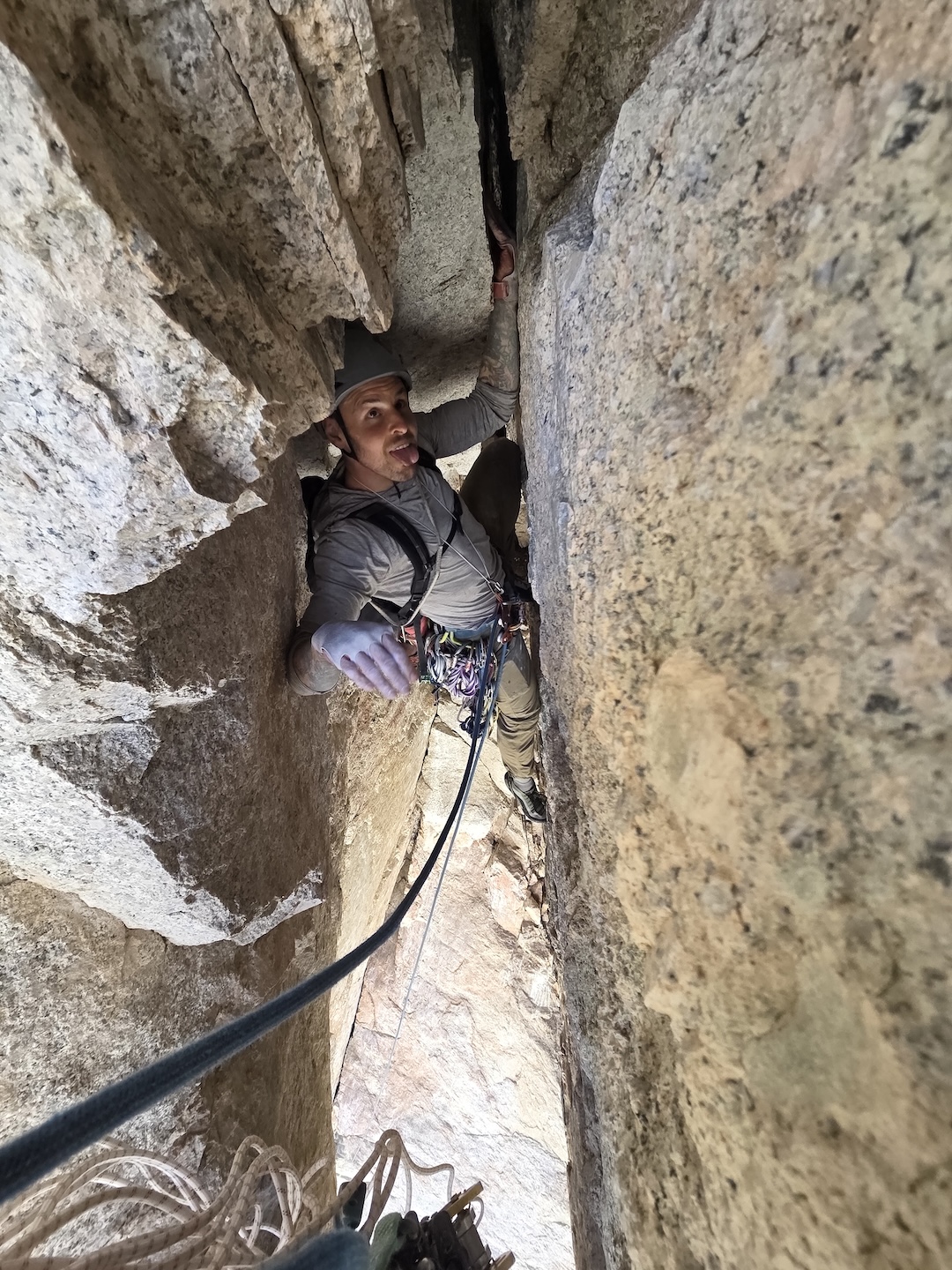 Andrew Tumbusch squeezing through the bomb-bay chimney pitch on Journey to the Center of the Earth (1,000’, 8 pitches, 5.10) on the Sky Blue Diamond.