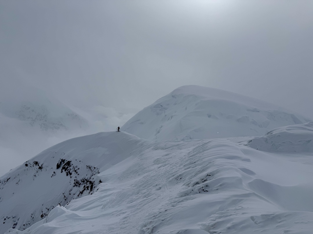 Pausing on the Crosson ridgeline after an icy section of the ski traverse. 
