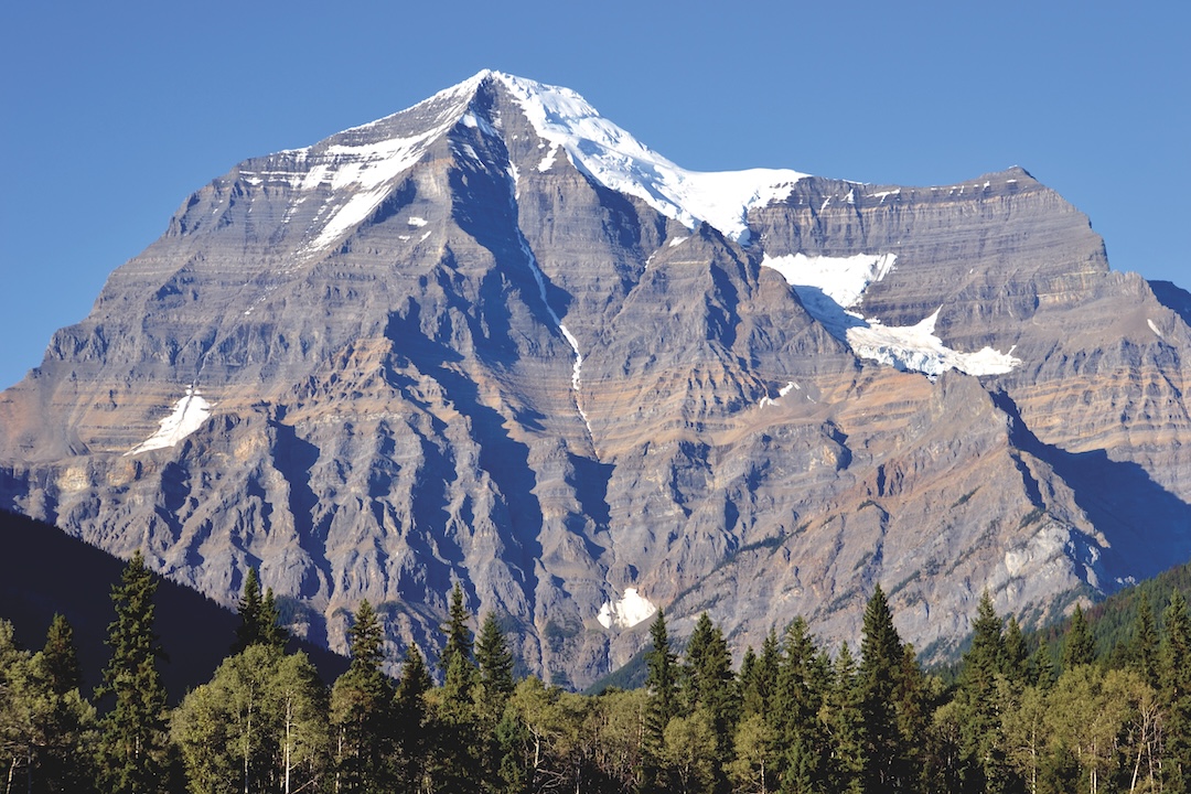 Mt. Robson is majestic when viewed from afar. The Wishbone Arête traverses the lower face to gain the sharp ridge diagonaling up and left to the summit. In August 2024, a trio of climbers was nearing the top when one of their party fell. 
