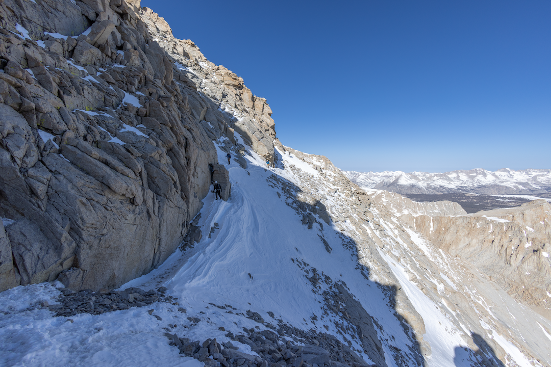  In March, the Traverse—also called the Easy Walk-Off—looks benign from a distance. In anything but dry summer conditions, it is frequently glazed with firm névé or faceted snow over ice. These conditions can prove fatal for a misstep. 
